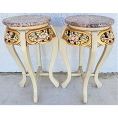 two small tables with flowers painted on them