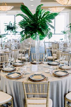 a table set up with plates and place settings for an elegant wedding reception at the four seasons resort