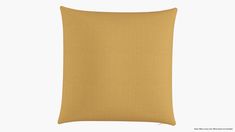 a yellow pillow on a white background with the back side facing up to the camera