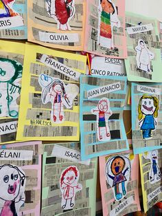 many children's drawings are hanging on the wall with newspaper clippings attached to them