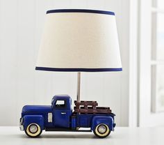 a blue truck lamp sitting on top of a table