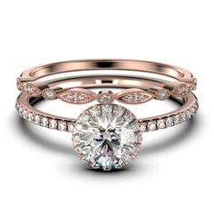 a rose gold engagement ring set with an oval cut diamond in the center and side stones on