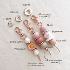 several different types of bead charms on a white surface with measurements for each item