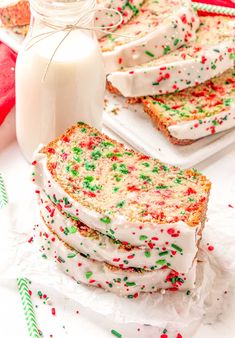 slices of cake with white frosting and sprinkles next to a bottle of milk