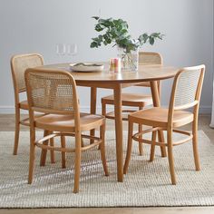 a wooden table with four chairs around it