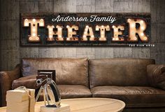 a living room with a couch, table and sign on the wall that says anderson family theater