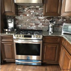 a stove top oven sitting inside of a kitchen next to wooden cabinets and counter tops