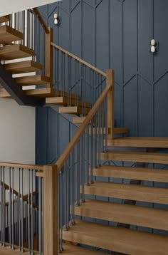 there is a stair case in the room with blue walls and wooden steps on the second floor