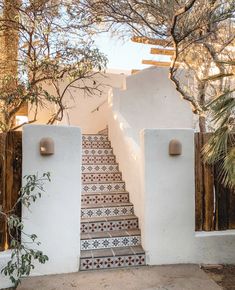 an outdoor staircase with tiled steps leading up to the house