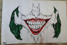 a drawing of a joker's face with green leaves on the nose and teeth