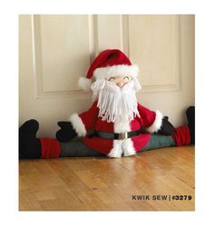 a stuffed santa clause sitting on the floor