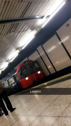 two people are waiting for the train to arrive at the subway station in london, england