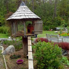 a bird house in the middle of a garden