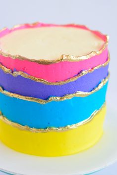 a multicolored cake sitting on top of a white plate