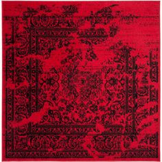 a red and black rug with ornate designs