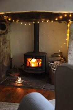 a wood burning stove sitting inside of a living room