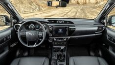 the interior of a car on a dirt road