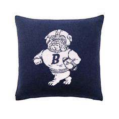 a blue pillow with a white bulldog on the front and black background, which reads b