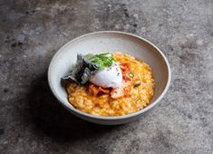 a white bowl filled with food on top of a table