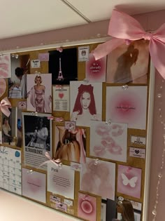 a bulletin board covered in pictures and pink ribbons with a large bow on the top