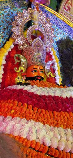 an elaborately decorated float with flowers and feathers