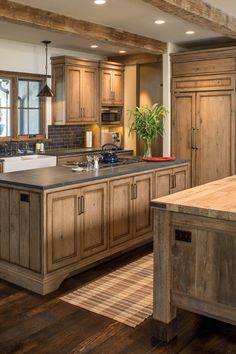 a large kitchen with wooden cabinets and an island