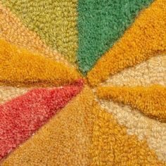 a multicolored area rug with an umbrella shaped design on the top and bottom