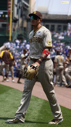 a baseball player standing on top of a field holding a catcher's mitt