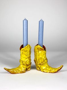 pair of yellow boots with blue candles in them