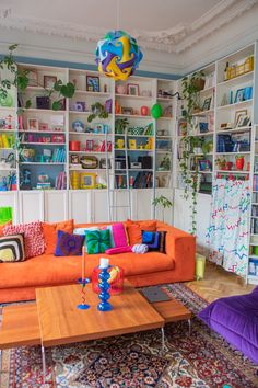 a living room filled with lots of colorful furniture