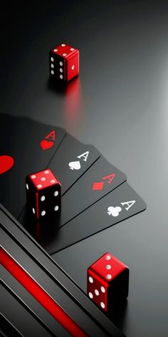 three red dices and four black dices sitting on top of each other in front of a dark background