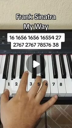 a person is playing the piano with their fingers and finger pressing it to play music