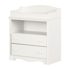 a white baby crib with two drawers on the bottom and an open shelf above it