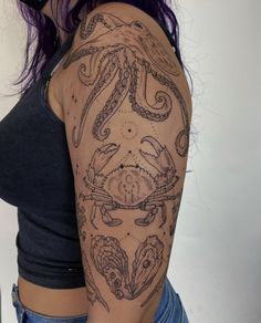 a woman's arm with an octopus tattoo on her left shoulder and the other half sleeve