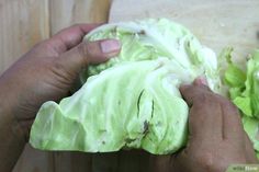 someone is peeling lettuce on a cutting board