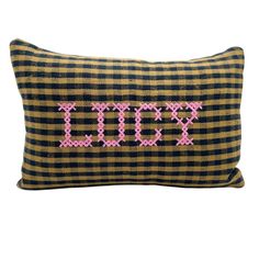 a black and yellow plaid pillow with pink cross stitching on the front that says,'xoxo '