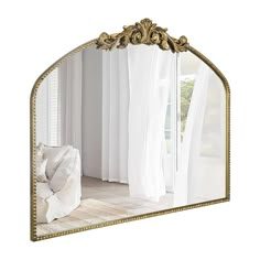 a mirror that is sitting on top of a rug in front of a white couch