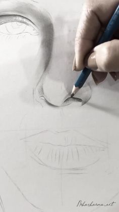 someone is drawing a face with a pencil