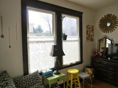 a living room filled with furniture and a flat screen tv on top of a dresser