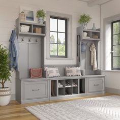 a white and gray entryway with lots of storage