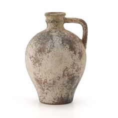 a brown and white vase sitting on top of a table