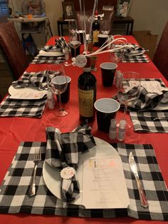 a table set with place settings and wine bottles