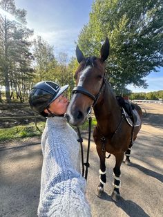 a person is petting a horse on the nose