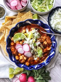 a bowl filled with beans and vegetables next to tortilla chips