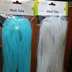 two bags of mesh tube sitting on top of a table