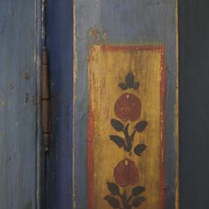 an old painted door with flowers on it