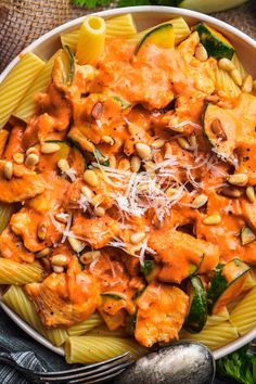 a white bowl filled with pasta covered in sauce