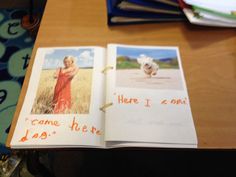 an open book on a table with pictures and words written in orange marker writing next to it