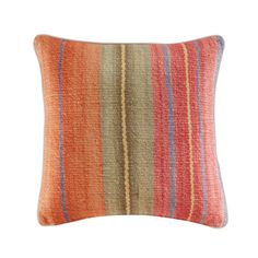 an orange and blue striped pillow on a white background