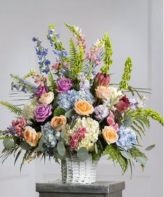 a basket filled with lots of different colored flowers